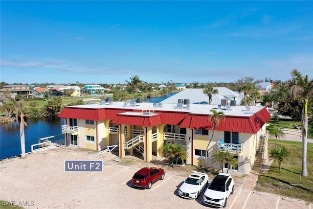 exterior space featuring a water view and uncovered parking