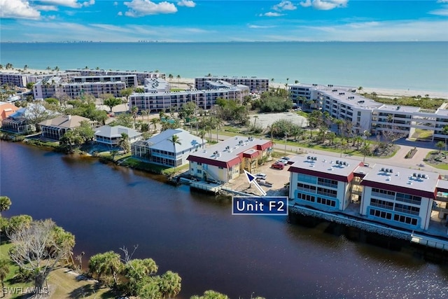 birds eye view of property featuring a water view and a city view