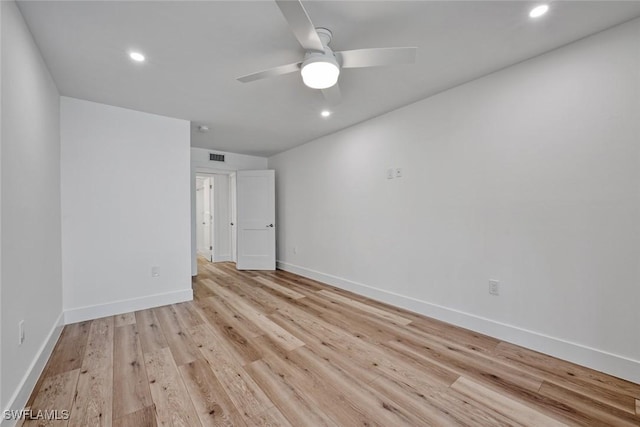 spare room featuring recessed lighting, light wood-type flooring, a ceiling fan, and baseboards