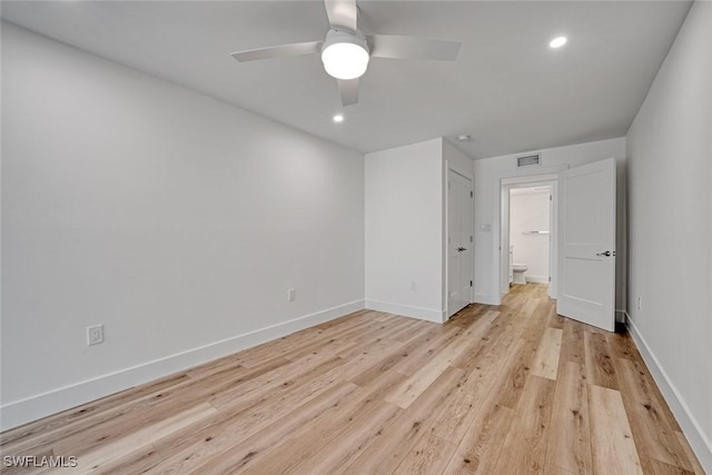 unfurnished bedroom with a ceiling fan, visible vents, light wood-style flooring, and baseboards