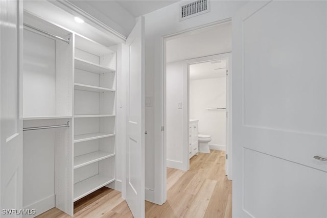 spacious closet featuring light wood-style floors and visible vents