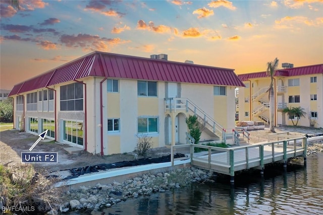 view of property with a water view and stairway