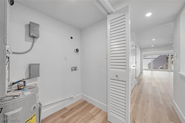 washroom featuring laundry area, baseboards, light wood-style flooring, electric dryer hookup, and recessed lighting