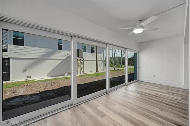 unfurnished sunroom featuring ceiling fan