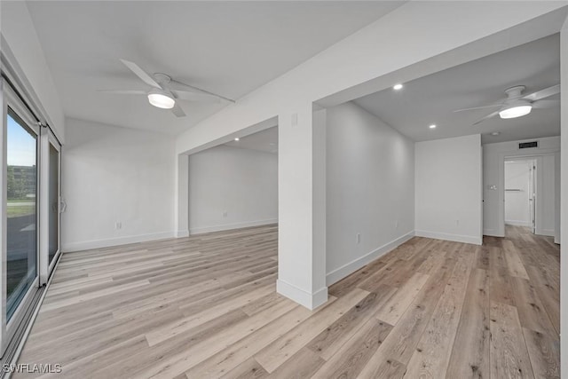 empty room with baseboards, light wood-style flooring, visible vents, and a ceiling fan