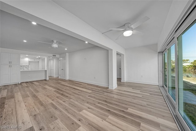 unfurnished living room featuring light wood-type flooring, baseboards, a ceiling fan, and recessed lighting