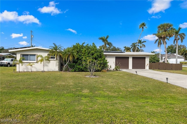 single story home featuring a front lawn and a garage