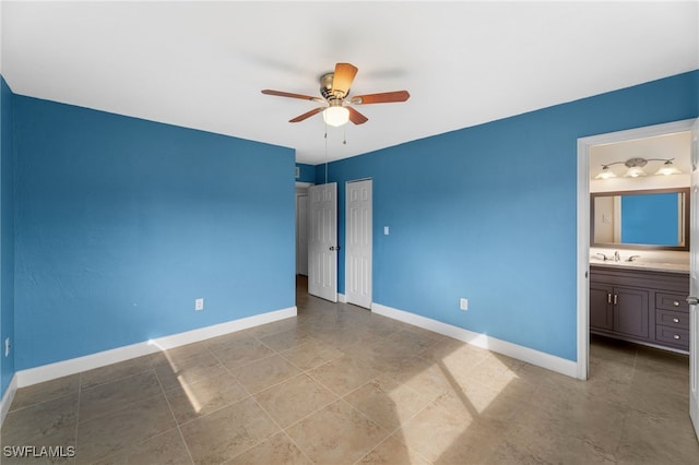 unfurnished bedroom with ceiling fan and connected bathroom