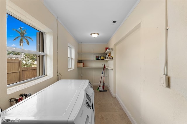 clothes washing area with independent washer and dryer and ornamental molding