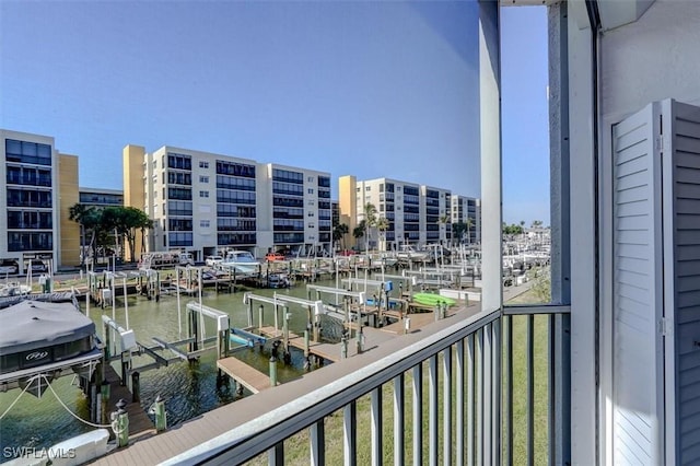 balcony with a water view and a boat dock