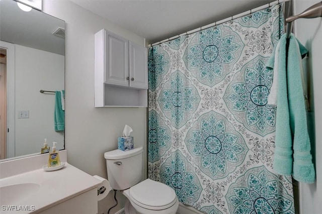 bathroom with vanity, a shower with shower curtain, and toilet