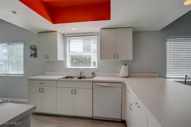 kitchen with dishwasher, white cabinets, and sink