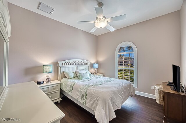 bedroom with ceiling fan and dark hardwood / wood-style flooring