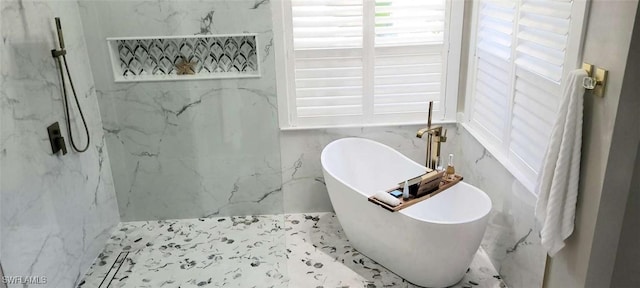 bathroom with a tub to relax in