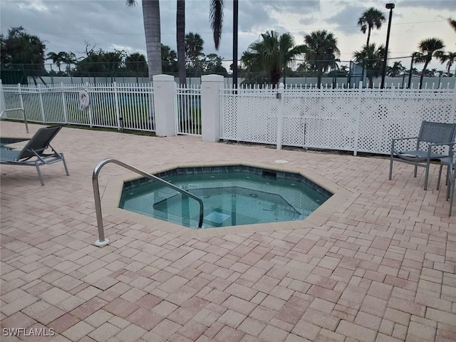 view of swimming pool with a patio area and a community hot tub