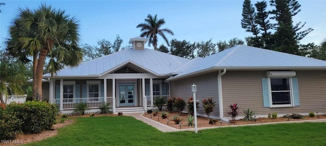 view of front of property featuring a front lawn and a wall mounted air conditioner