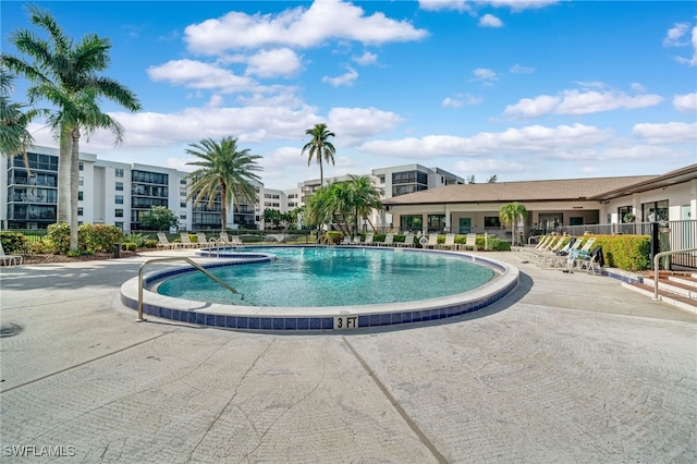 community pool featuring a patio area