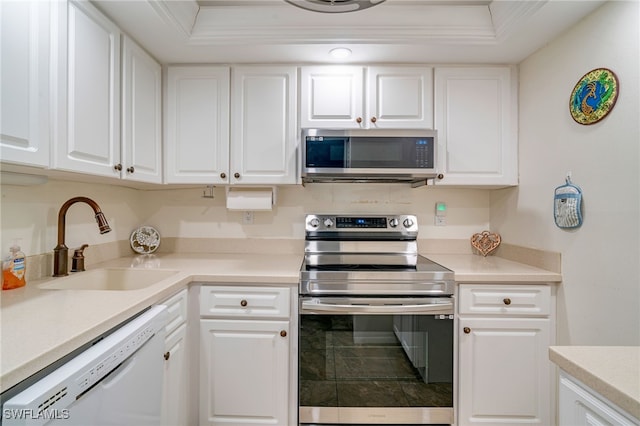 kitchen with white cabinetry, appliances with stainless steel finishes, light countertops, and a sink