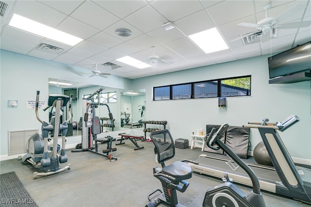 gym featuring ceiling fan, a drop ceiling, and visible vents