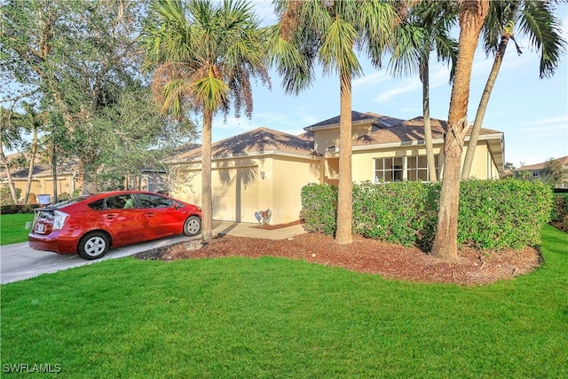 view of front facade with a front yard and a garage