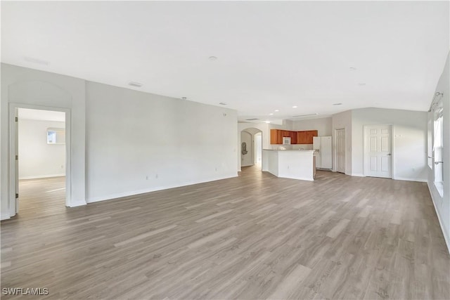 unfurnished living room featuring light wood-type flooring