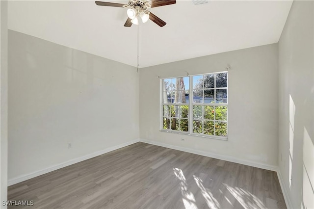 empty room featuring hardwood / wood-style flooring and ceiling fan