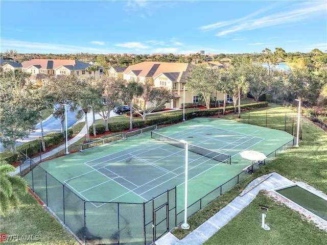 view of sport court featuring a lawn