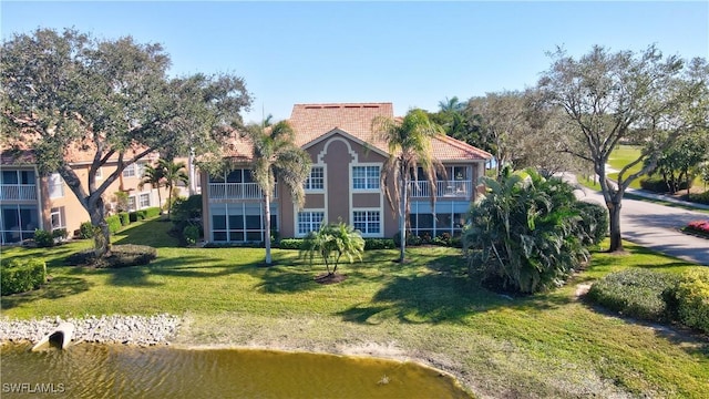 exterior space with a lawn and a water view