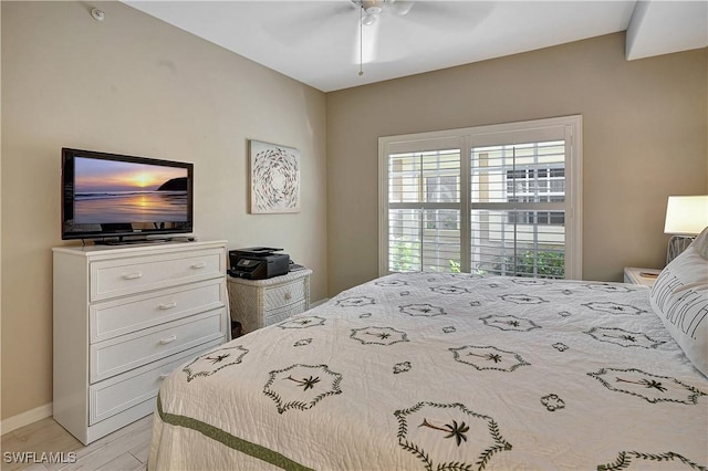 bedroom with ceiling fan and light hardwood / wood-style flooring