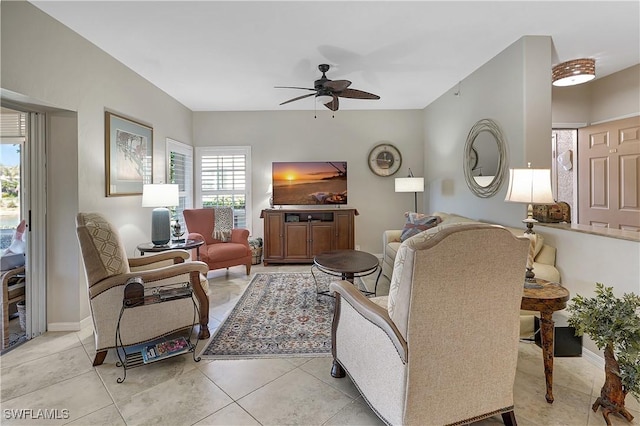 tiled living room with ceiling fan