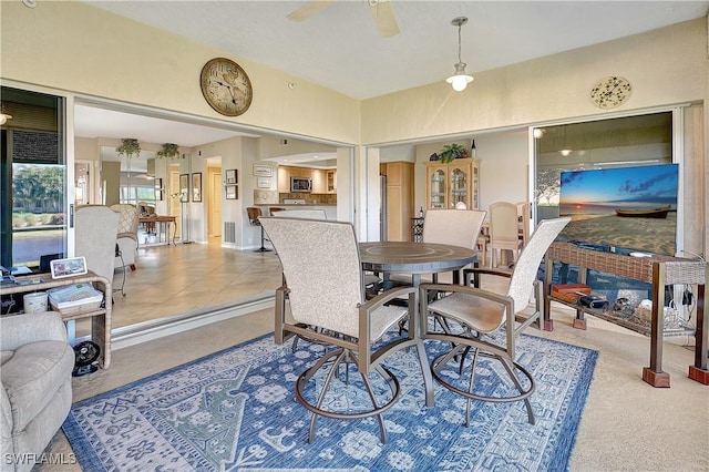 dining room with light tile patterned floors and ceiling fan