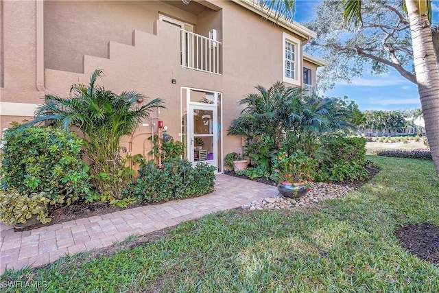 doorway to property with a yard