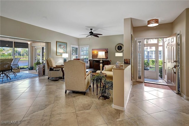 tiled living room featuring ceiling fan