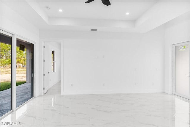 unfurnished room with a tray ceiling and ceiling fan