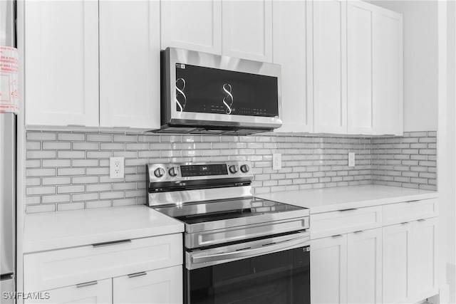 kitchen featuring white cabinetry, stainless steel appliances, and tasteful backsplash