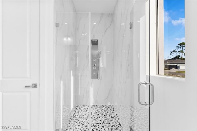 bathroom with a shower with door