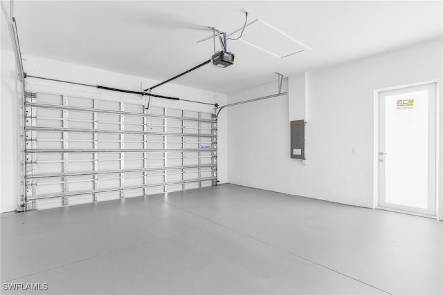 garage featuring electric panel and a garage door opener