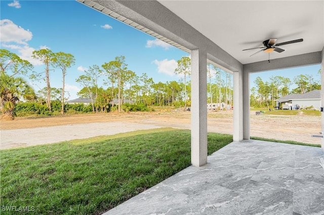 view of yard featuring ceiling fan