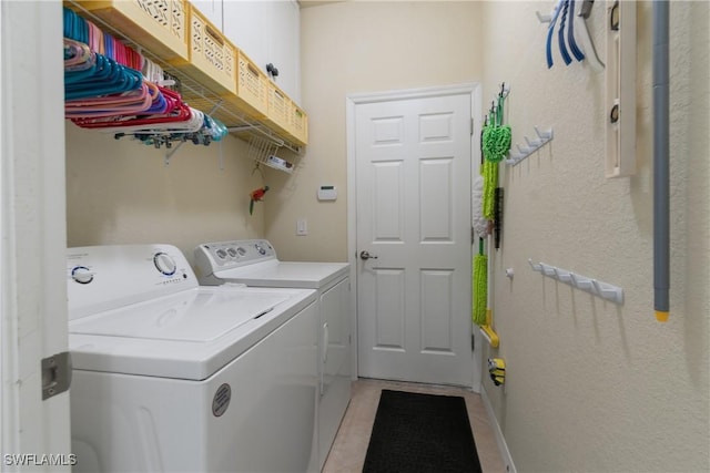 washroom with light tile patterned floors and washer and clothes dryer