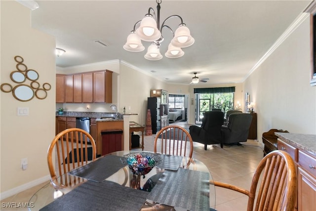 dining room with ceiling fan with notable chandelier, light tile patterned floors, sink, and ornamental molding