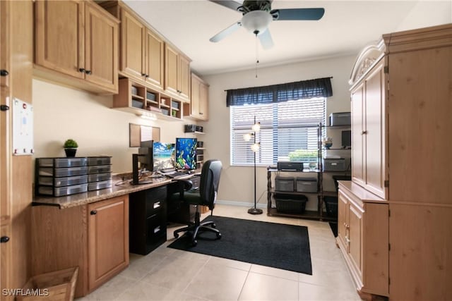 tiled home office featuring ceiling fan