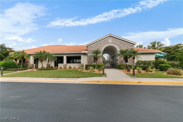 mediterranean / spanish-style house with a front yard