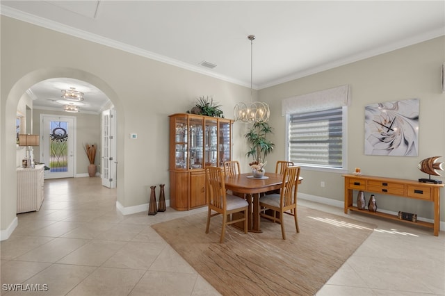 tiled dining area featuring a notable chandelier and crown molding