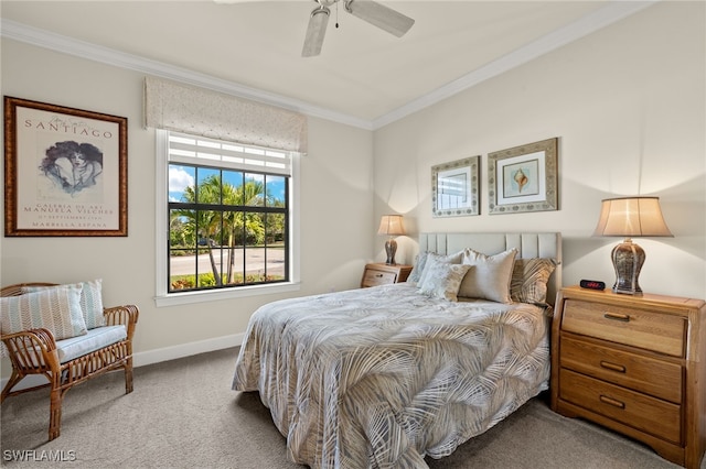 carpeted bedroom with ceiling fan and ornamental molding