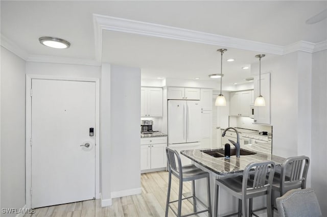 kitchen featuring white cabinets, decorative backsplash, white appliances, and sink