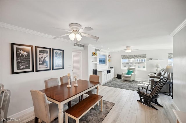 dining space featuring ceiling fan, light wood-type flooring, and ornamental molding