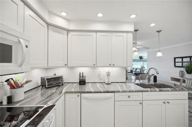 kitchen with white cabinetry, sink, ceiling fan, backsplash, and white appliances