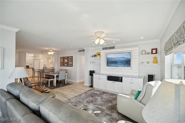 living room featuring ceiling fan, light hardwood / wood-style floors, and ornamental molding