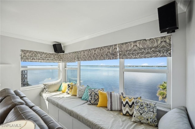 sunroom featuring a water view