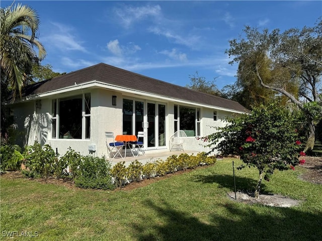 rear view of property featuring a yard